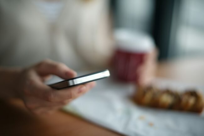 selective focus photography of person holding gray phone, Oppo A78